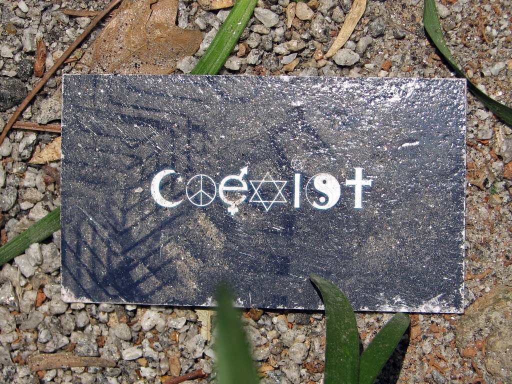 A stone with the Coexist slogan on it.